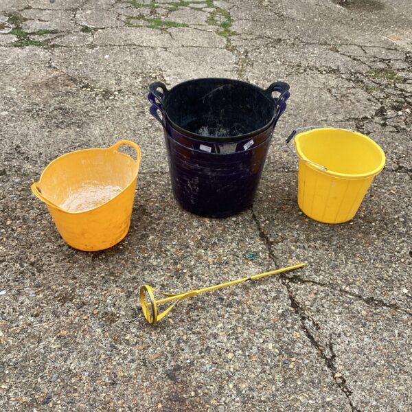 Two plastic plaster mixing buckets with a paddle for DIY projects.