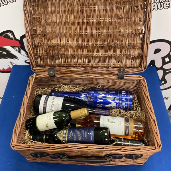 Luxury festive hamper with champagne and port bottles inside.