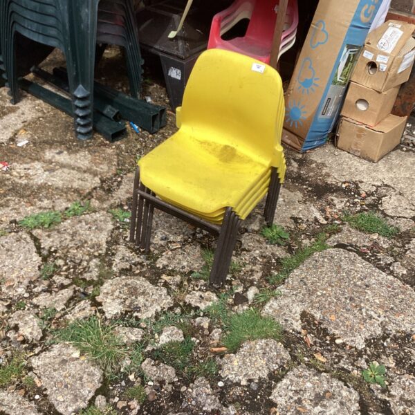 Vintage yellow plastic childrens chair for playroom or garden.