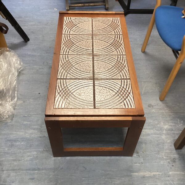 Vintage tile top coffee table with circular pattern.