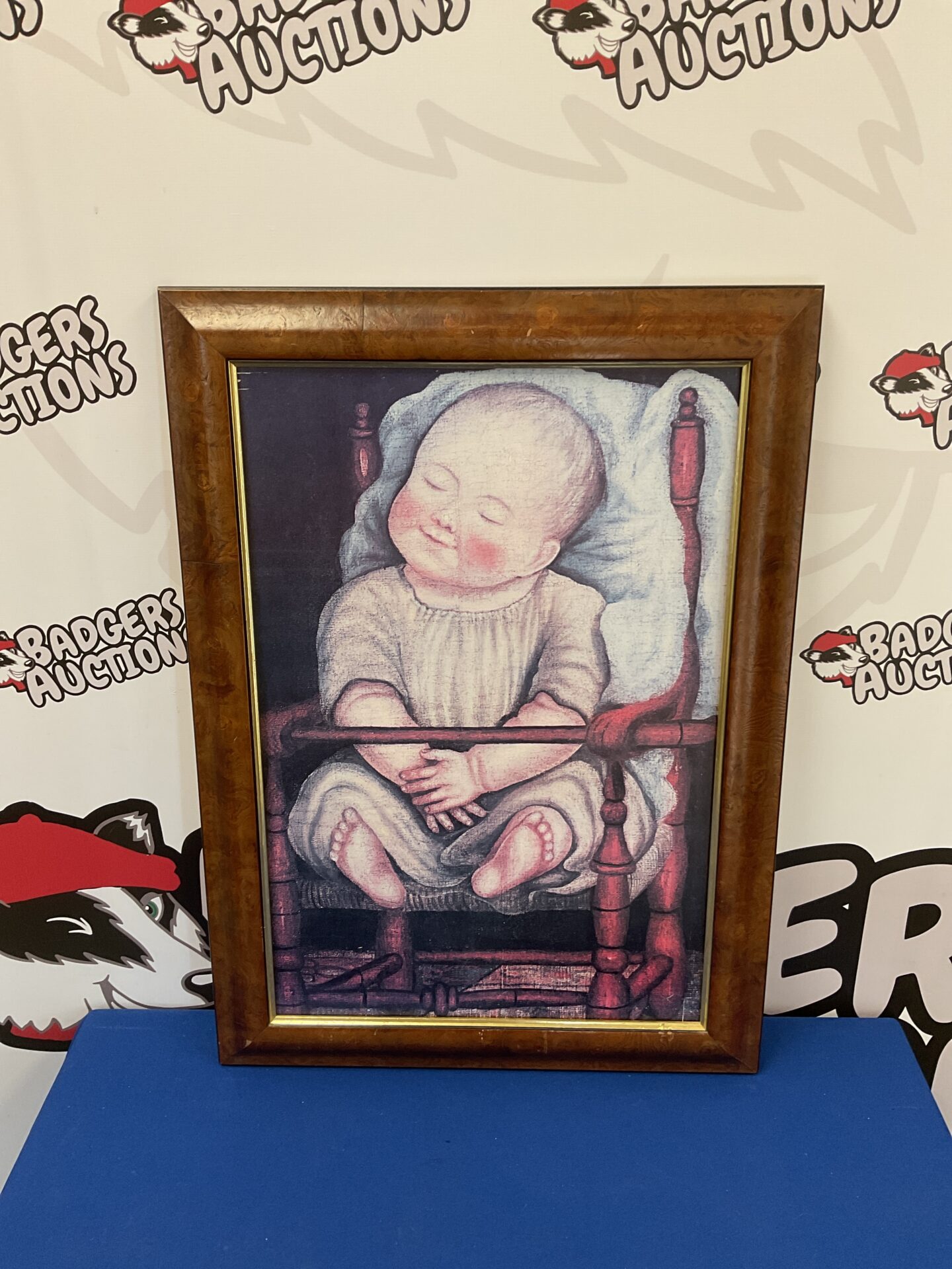 702 Framed print of a baby in red chair by anonymous American artist