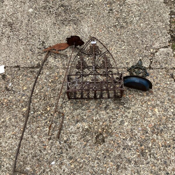 Ornate vintage metal garden wall flower basket for outdoor display.