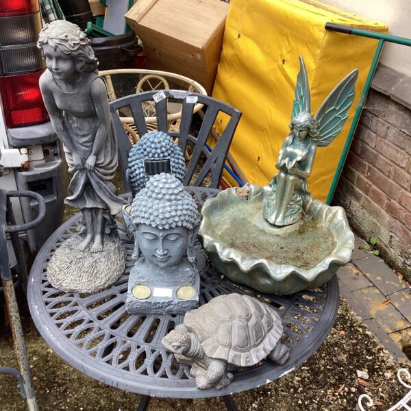 Garden ornaments including a birdbath and sculpted turtle.