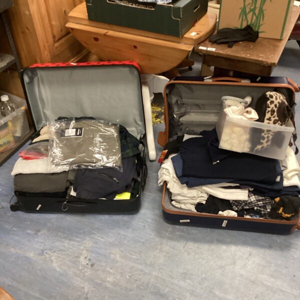 Vintage suitcases and a drawer of mixed clothing for collectors.
