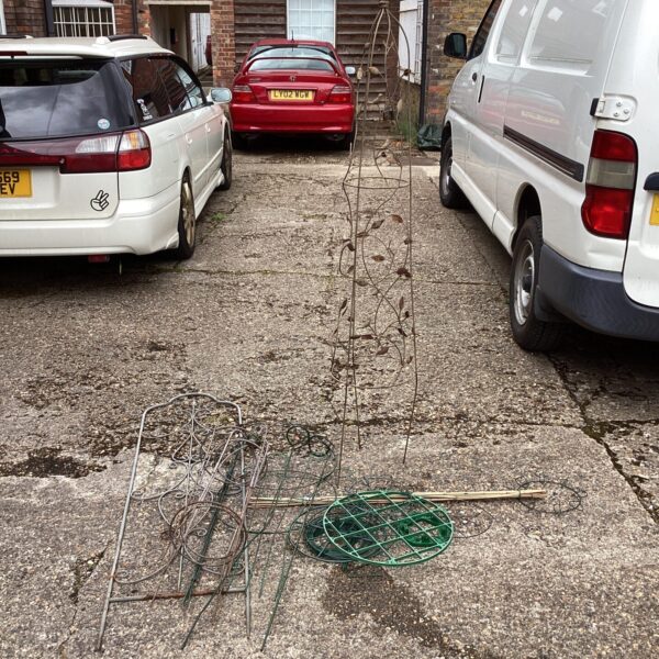 Lot of metal garden plant climbing frames for supporting plants.