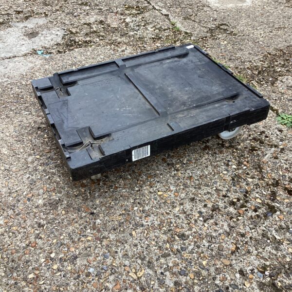 Durable plastic dolly skate for moving pallets and heavy loads.