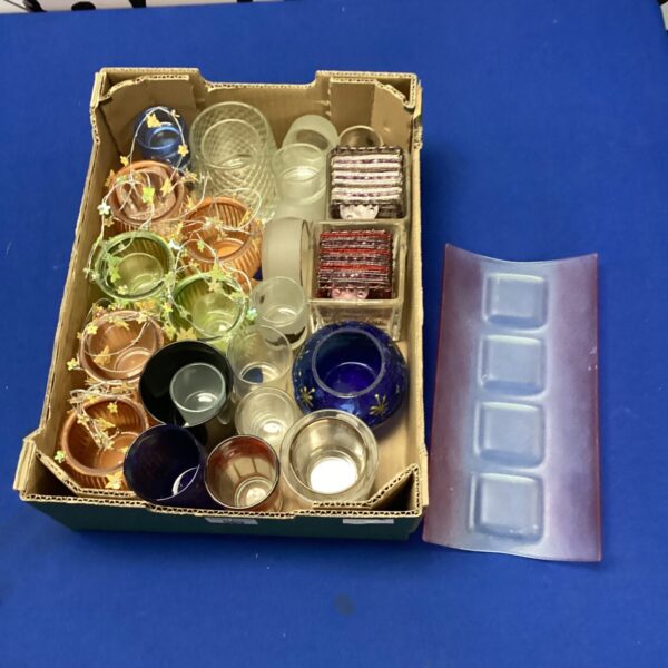 Lot of mixed glass candle holders in various colours and styles.
