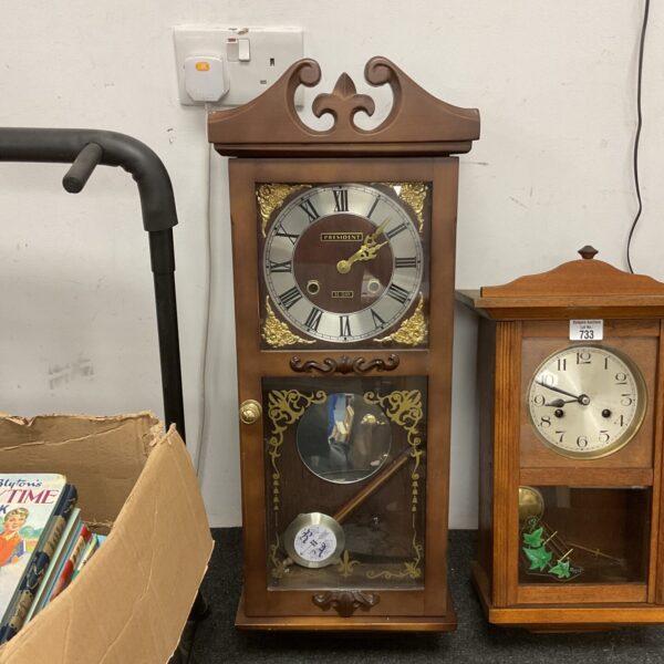 Vintage President wall clock with pendulum and Roman numerals.