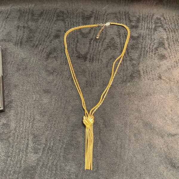 Vintage 1950s yellow metal rope necklace with knot detail.