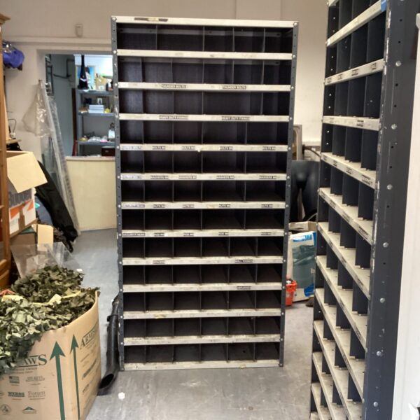Vintage metal storage unit with multiple bins for organization.