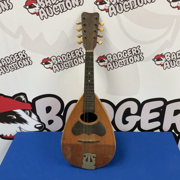 Vintage sunburst mandolin awaiting restoration.