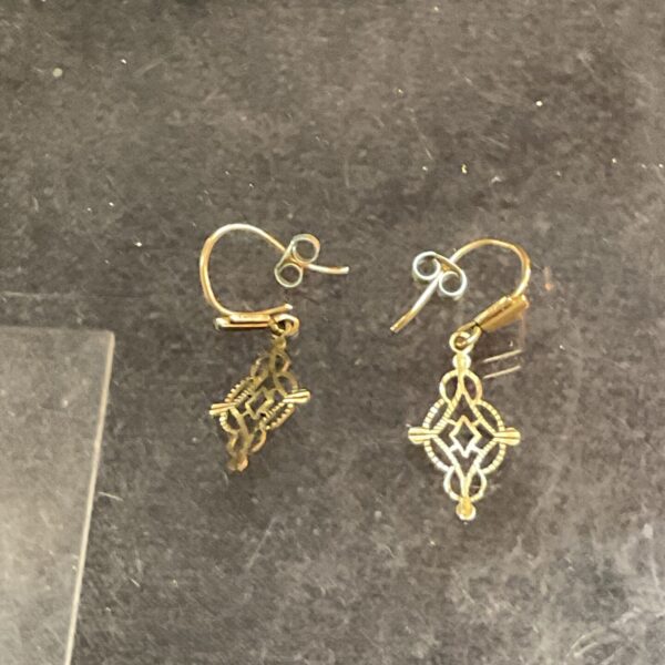 Delicate 9ct gold drop earrings with a floral design.