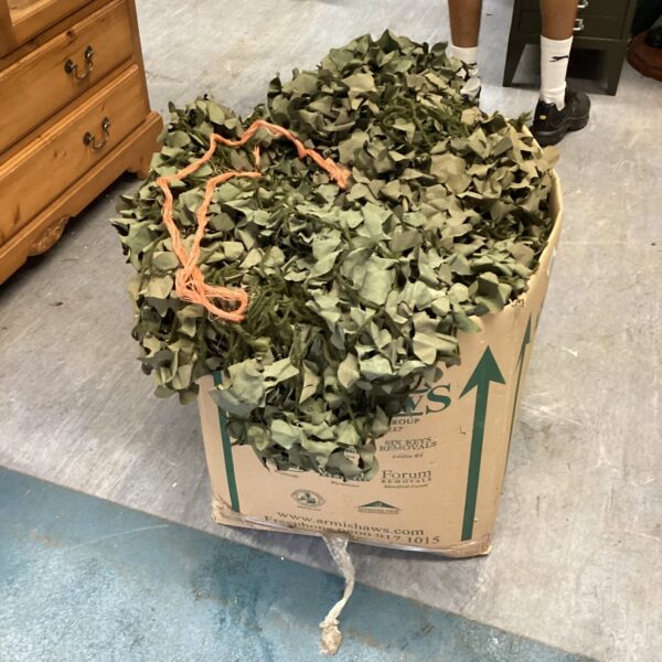 Box of green and brown camouflage netting for outdoor use.
