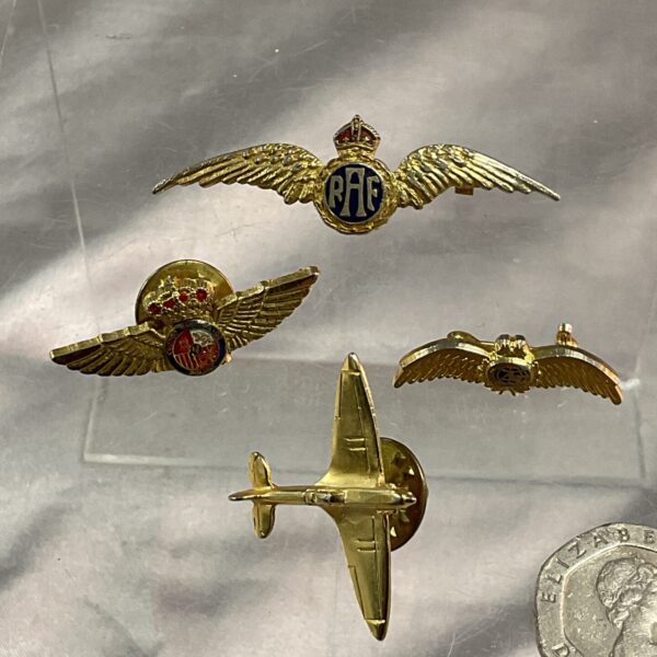 Vintage RAF Spitfire brooch and aviation wing badges collection.