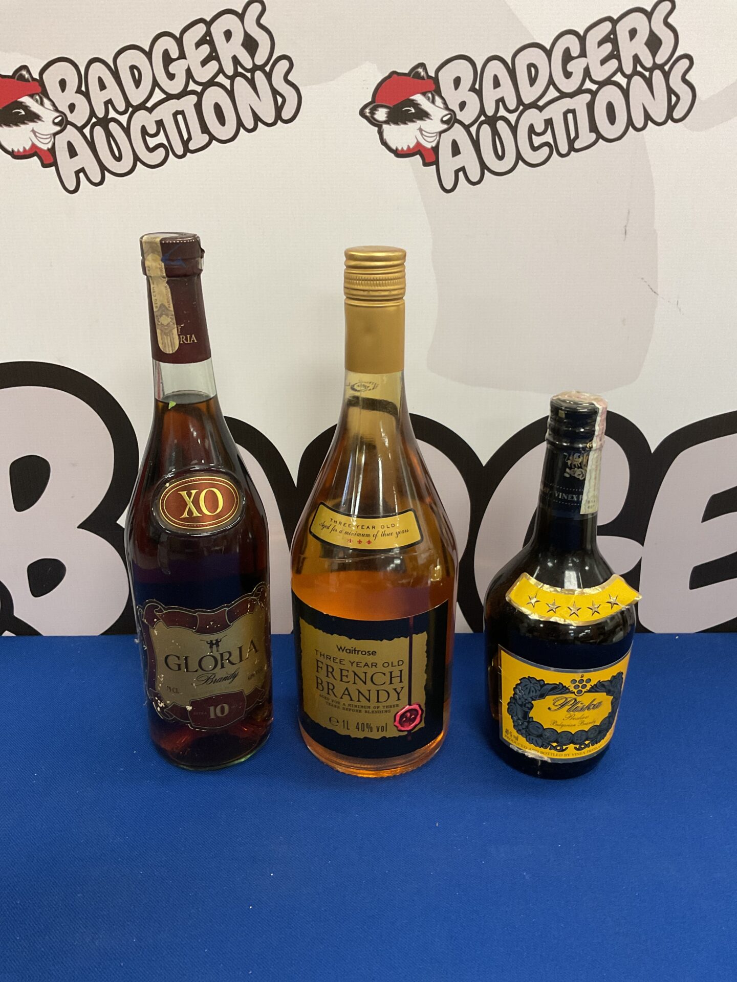 912 Three sealed bottles of brandy inc gloria & pliska