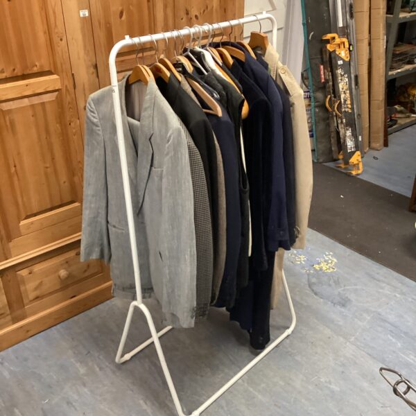 Gents clothing rail displaying assorted jackets including a Dannimac coat.