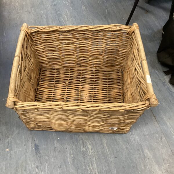 Large woven wicker log basket for firewood storage.