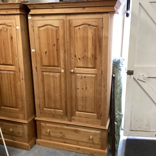 Vintage pine wardrobe with two drawers and ample storage space.