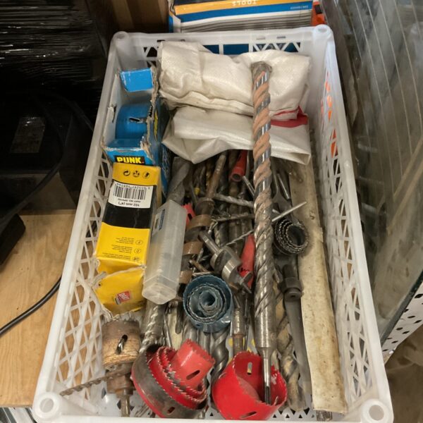 Assorted drill bit set and hole saws in a plastic tray.