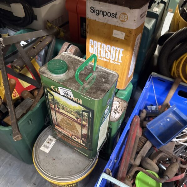 Lot of fence paint and creosote tins for garden wood treatment.