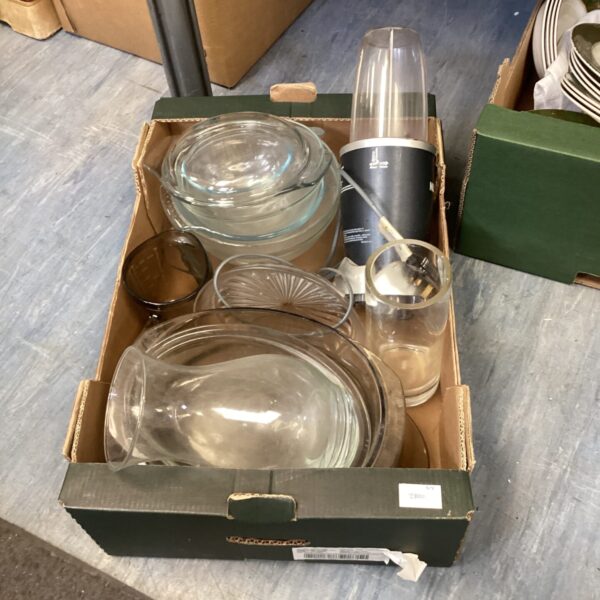 Mixed lot of kitchen bowls and a Nutribullet blender for food preparation.