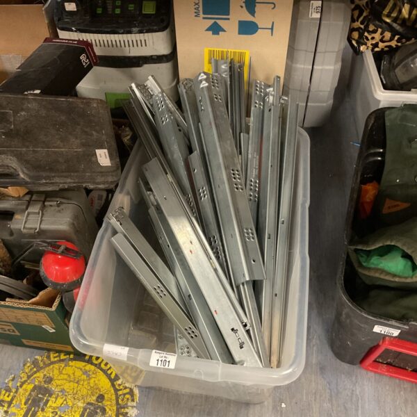 Large quantity of metal drawer runners for furniture projects.