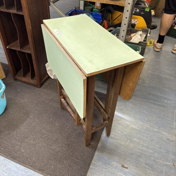 Vintage drop leaf table with Formica top, showing gate legs.