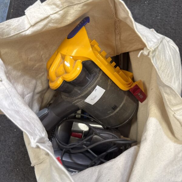 Front view of a grey and purple Dyson V8 cordless vacuum cleaner.