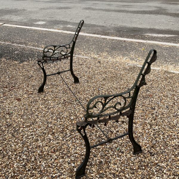 Ornate Victorian cast iron garden bench ends for restoration.