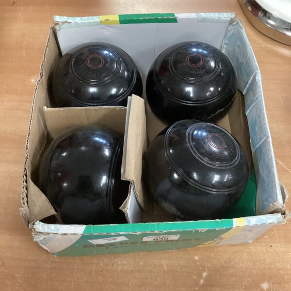 Set of four tyrolite lawn bowls for outdoor garden games.
