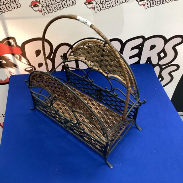 Vintage metal magazine basket with scrolled design.
