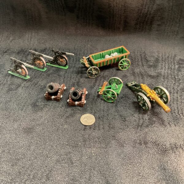 Vintage lead gun carriages and cannons, antique toy artillery collection.