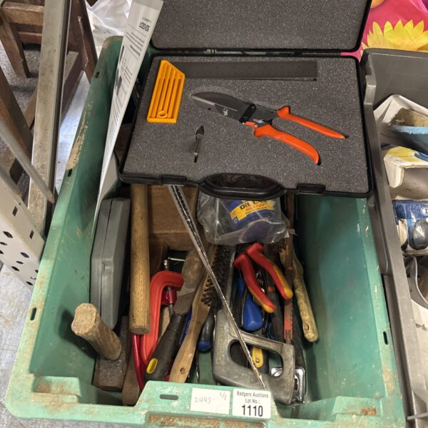 Assorted hand tools in a green storage box, workshop collection.
