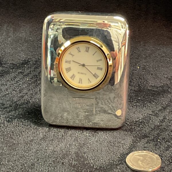Sleek Goldman Sachs quartz desk clock with white dial.