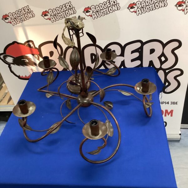 Ornate vintage metal chandelier with curved arms.