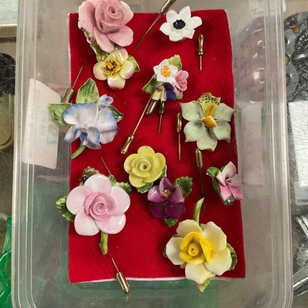 Vintage floral stick pins, including Coalport porcelain examples, for collectors.