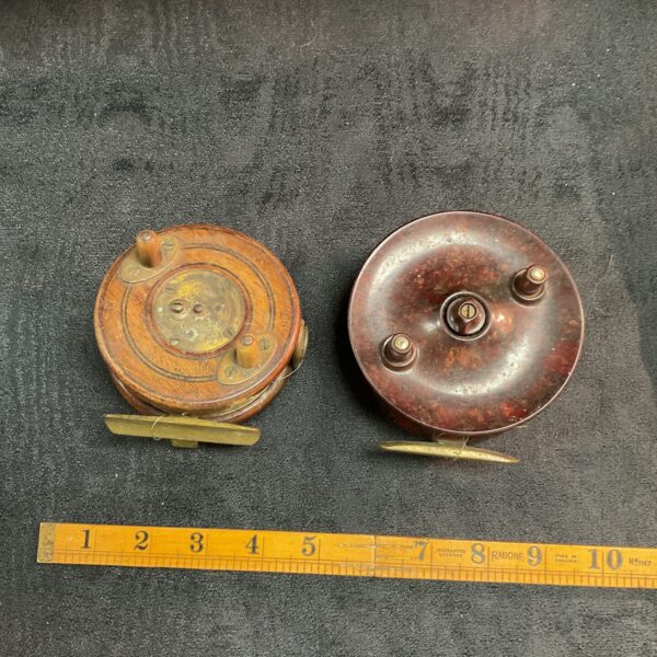 Antique wooden and brass fishing reel, vintage angling tackle.