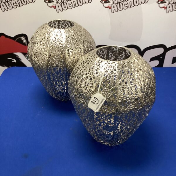 Pair of vintage metal lamp shades with floral pattern.