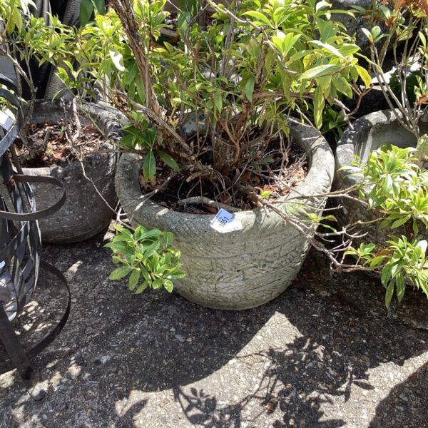 Large stone effect garden planter with plants.