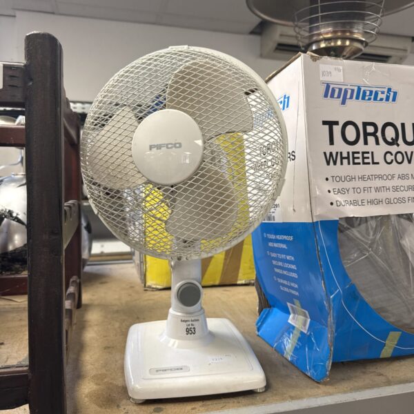 Vintage Pifco desk fan on a white surface.