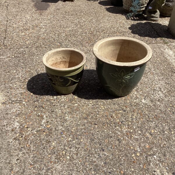 Pair of dark green glazed garden pots with floral details.