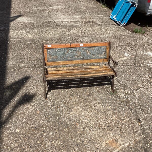 Vintage childs garden bench with wrought iron detailing.