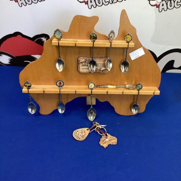 Vintage Australian tea spoons displayed on a rack.