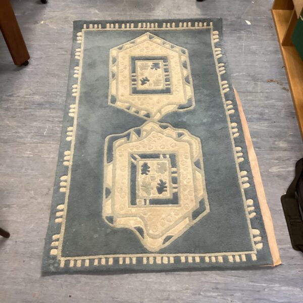 Vintage sky blue rug with geometric pattern.