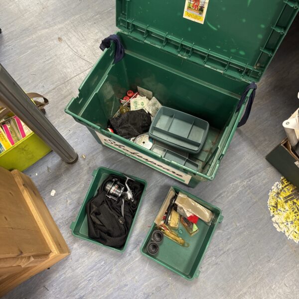 Vintage Shakespeare fishing tackle box filled with lures and tackle.