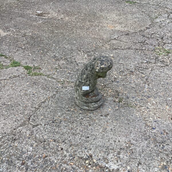 Concrete otter garden ornament in a garden setting.