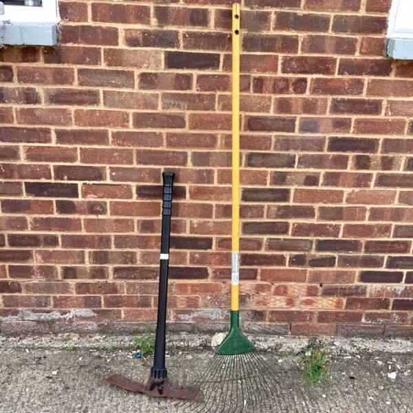 Vintage garden tools lot featuring a matock and rake.