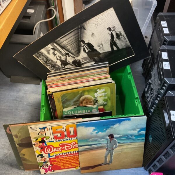 Vintage vinyl record lot with photograph prints on album covers.