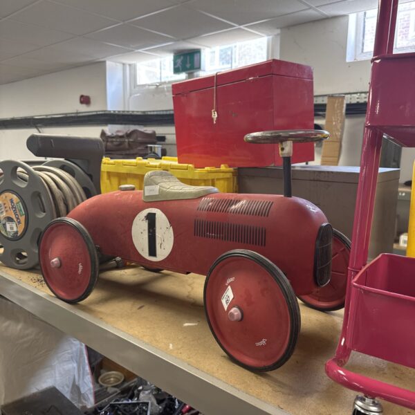 Red vintage Vilac ride-on car with white details.