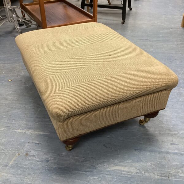 Vintage Duresta footstool with herringbone fabric and wooden legs.
